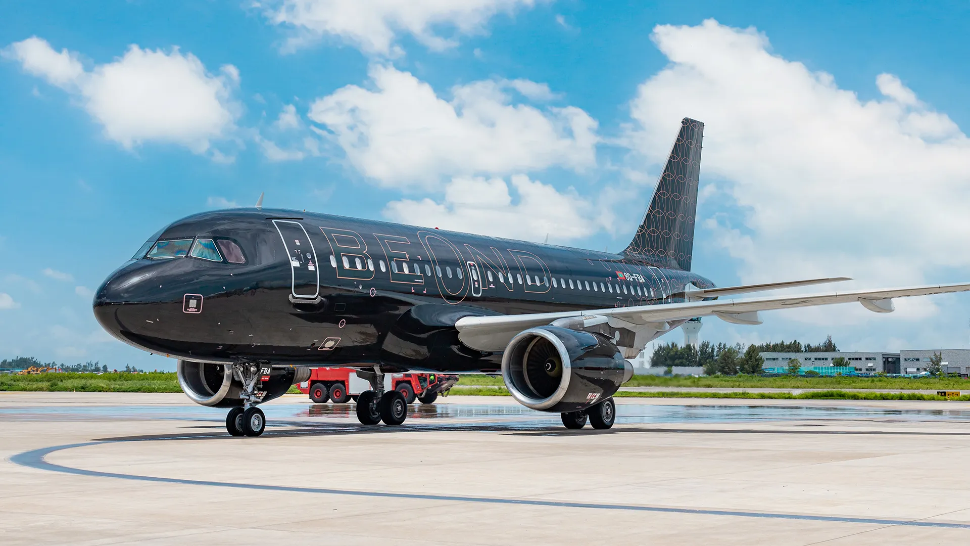 A sleek Four Seasons branded private jet parked on an tarmac, potentially with a luxurious Asian resort in the background.