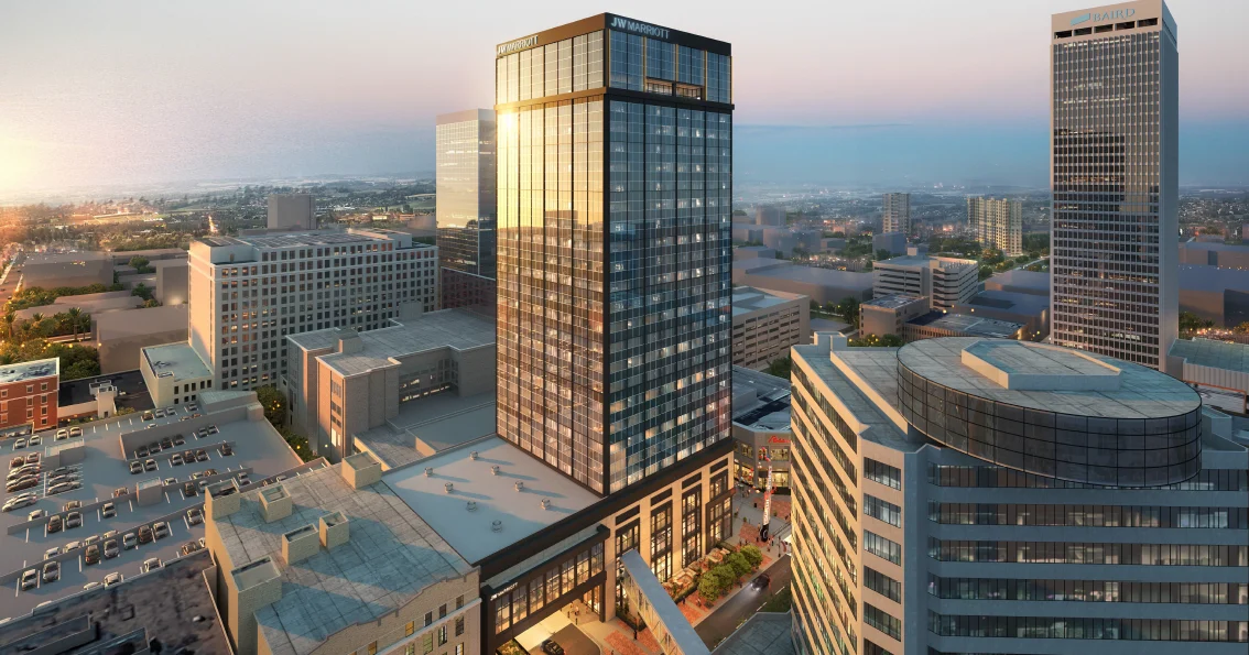 A towering downtown building, possibly the Brown & Williamson Tower, with construction scaffolding or demolition equipment visible