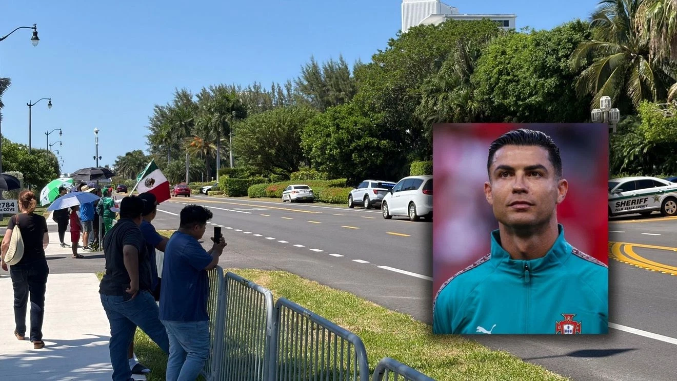 Fans gathered outside a luxury resort, possibly holding flags or signs, hoping to see a celebrity.