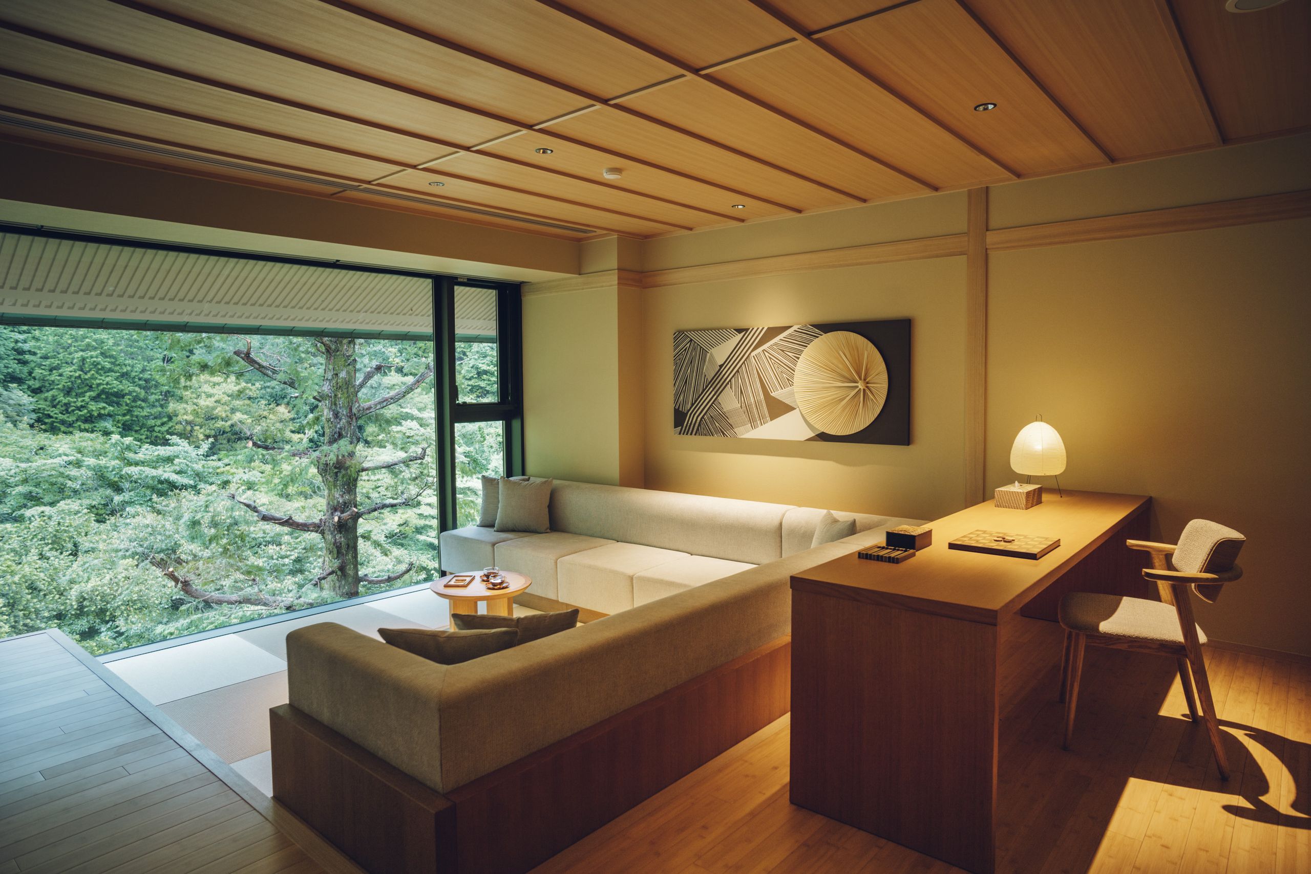 An elegant Japanese tea house with traditional architecture, surrounded by lush Hakone scenery, suggesting a tranquil and luxurious retreat.