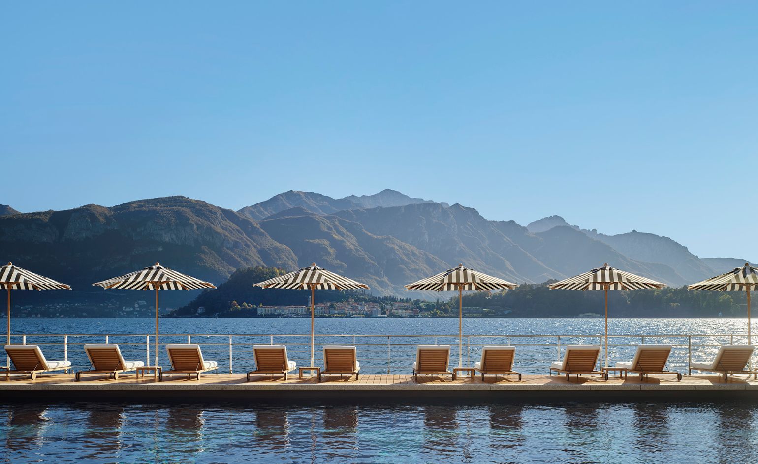 Exterior view of the Lake Como Edition hotel, showcasing its blend of traditional Italian architecture with modern design elements against the backdrop of Lake Como.