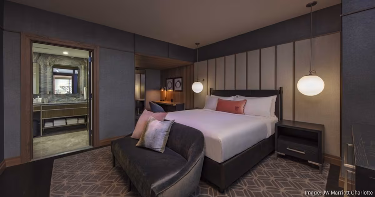 A well-appointed bedroom within the Presidential Suite at the JW Marriott Charlotte, featuring elegant furnishings and ample space.