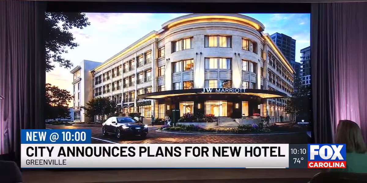 A modern, elegant hotel exterior at dusk with warm lighting.