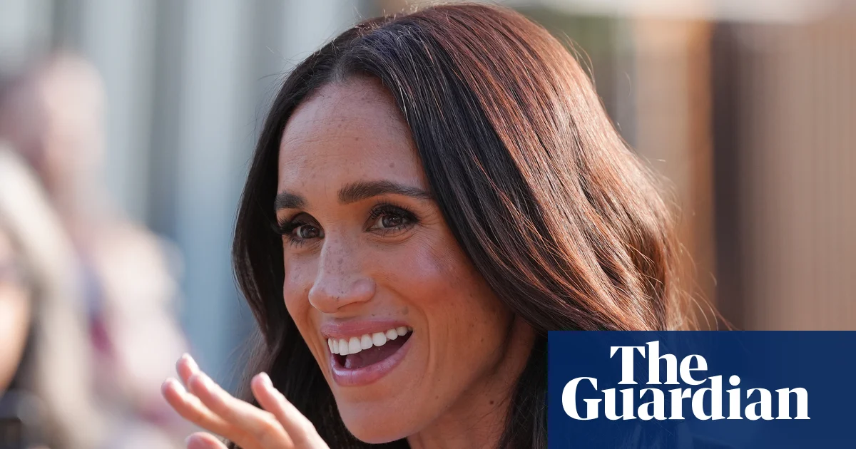 Meghan Markle on a past Australian tour smiling