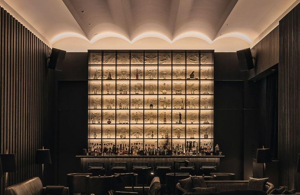 A meticulously crafted cocktail, possibly a classic like a Martini or Manhattan, served in an elegant glass on a polished bar, likely featuring an Asian-inspired garnish or minimalist aesthetic, repre