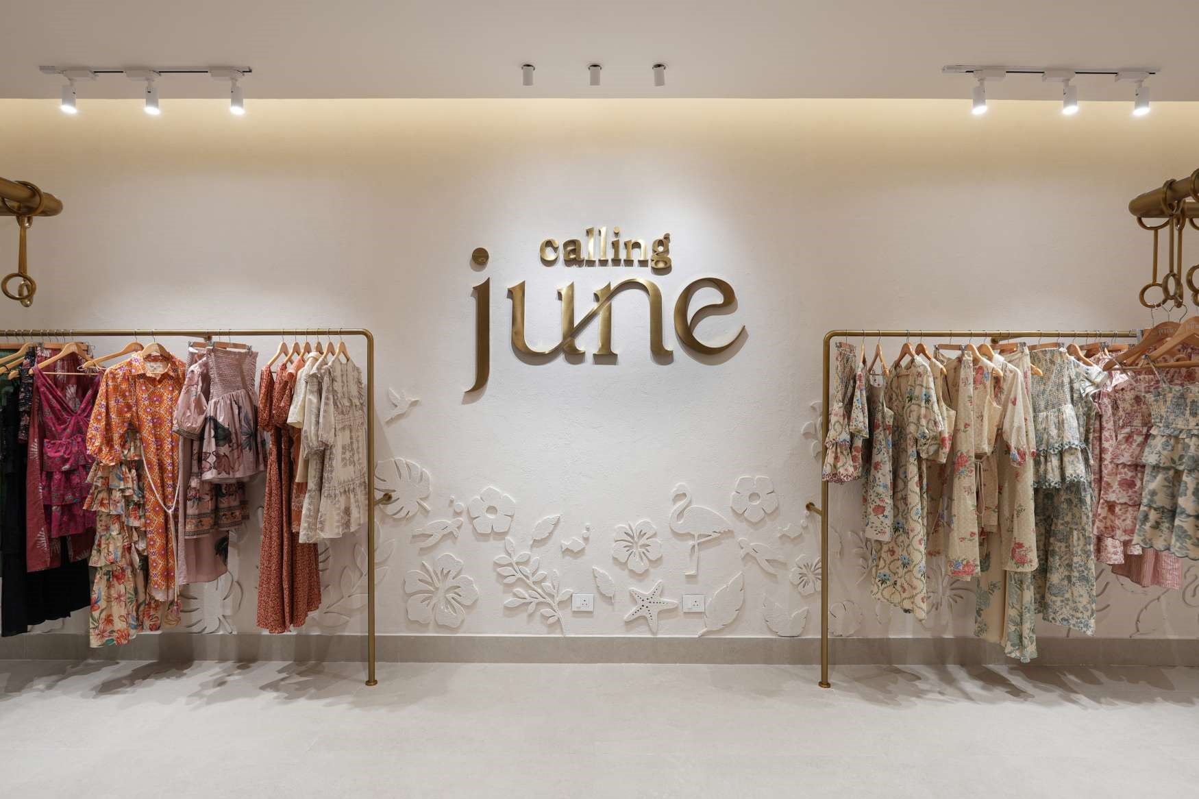Exterior view of the new Calling June flagship store at The Corridors, featuring a clean, minimalist design with a prominent brand logo.
