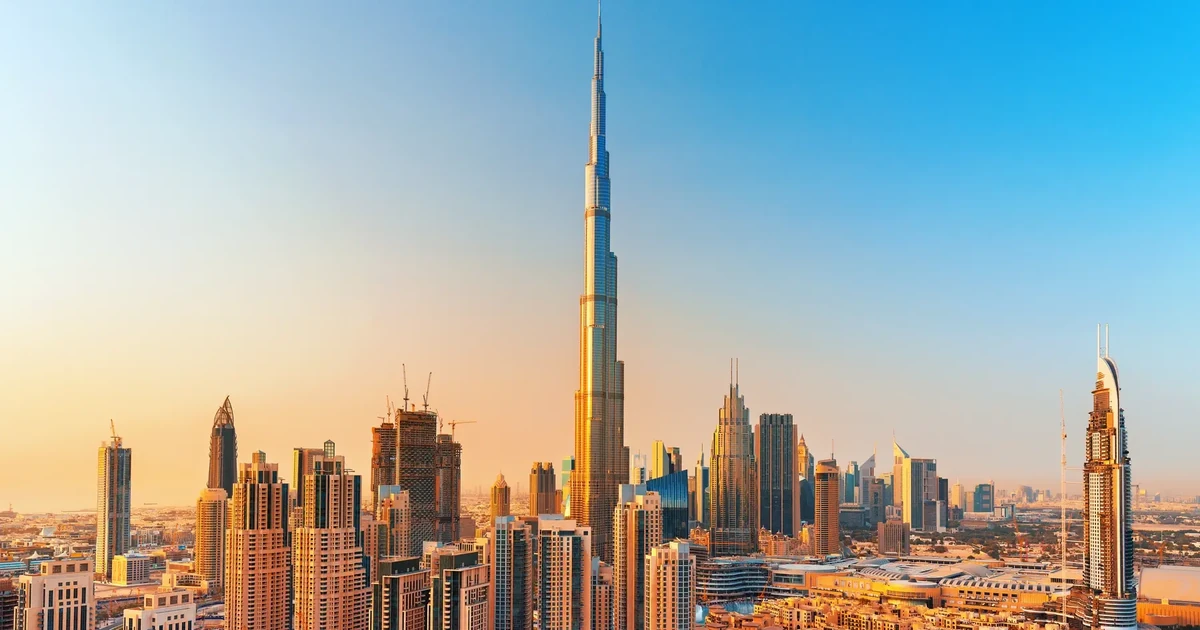 An Emirati billionaire standing before a backdrop of a city skyline, representing luxury hotel investment.