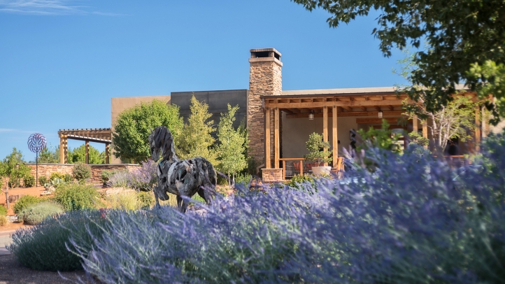 A sun-drenched adobe complex of the Four Seasons Resort Rancho Encantado Santa Fe, nestled in the high desert landscape.