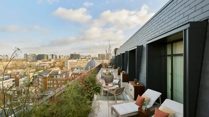 Exterior view of Six Senses London with a domed roof and surrounding urban architecture