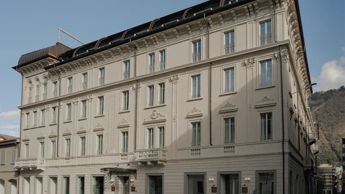 Exterior view of Palazzo San Gottardo on Lake Como, showcasing its classic Italian architectural details facade