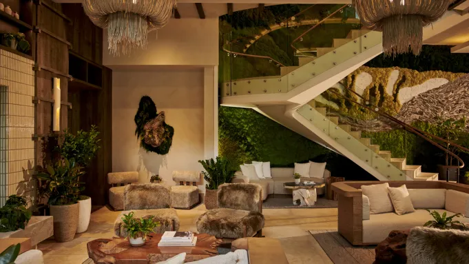 The lobby of 1 Hotel Seattle, featuring natural wood and abundant greenery