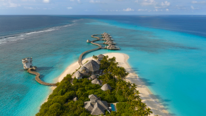 Aerial view of Soneva Secret villas on crystal-clear water
