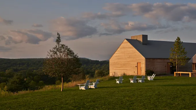 Exterior of Inness Clubhouse at twilight, with warm lights visible
