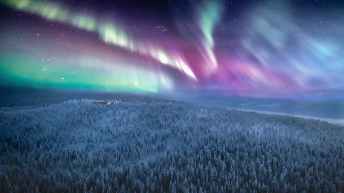 The Northern Lights illuminating a luxury lodge in the remote Finnish Lapland