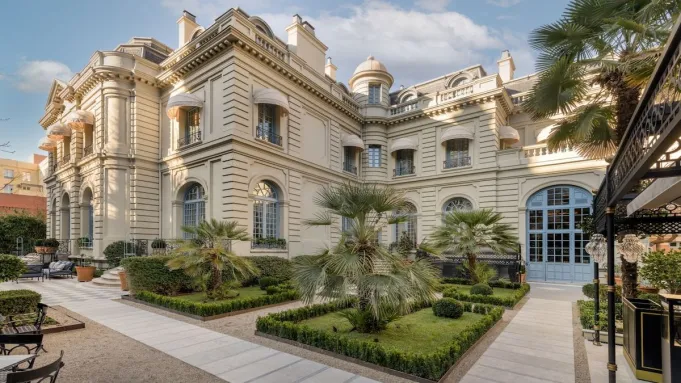 Exterior view of the historic Santo Mauro hotel, showcasing its stately architecture and surrounding gardens