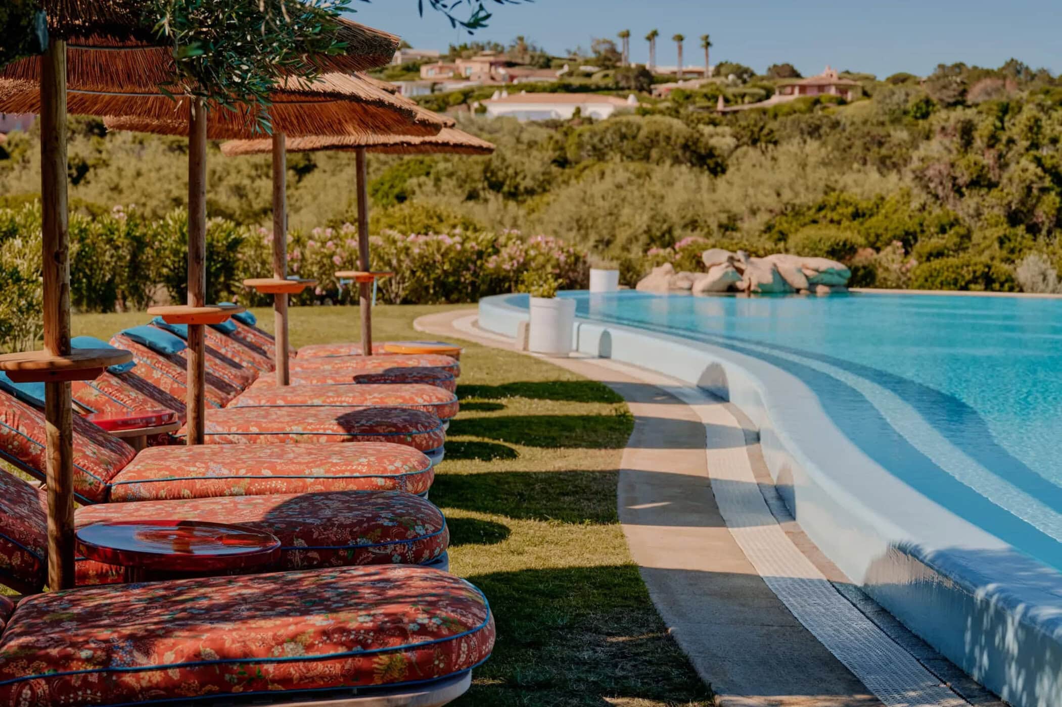 Etro branded poolside lounge chairs and umbrellas at Hotel Romazzino