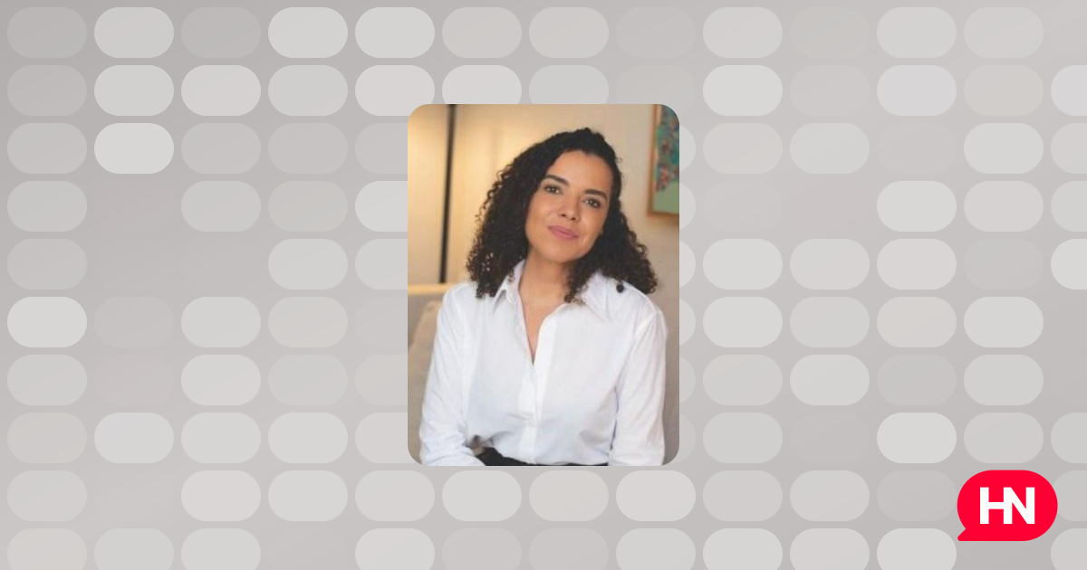 A portrait of Renata Portes, a woman with dark hair and a professional demeanor, likely taken in a hotel setting