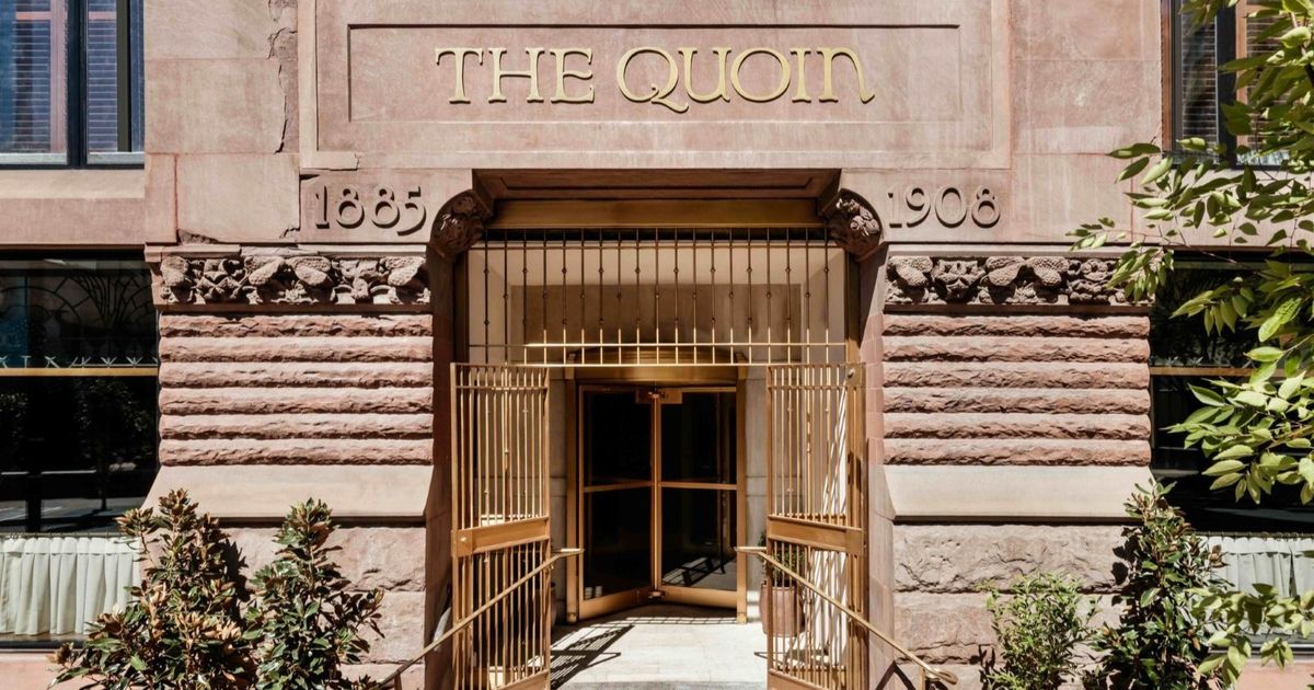 Exterior view of The Quoin Hotel & Restaurant, an elegant brownstone building with historic architecture in Wilmington, Delaware