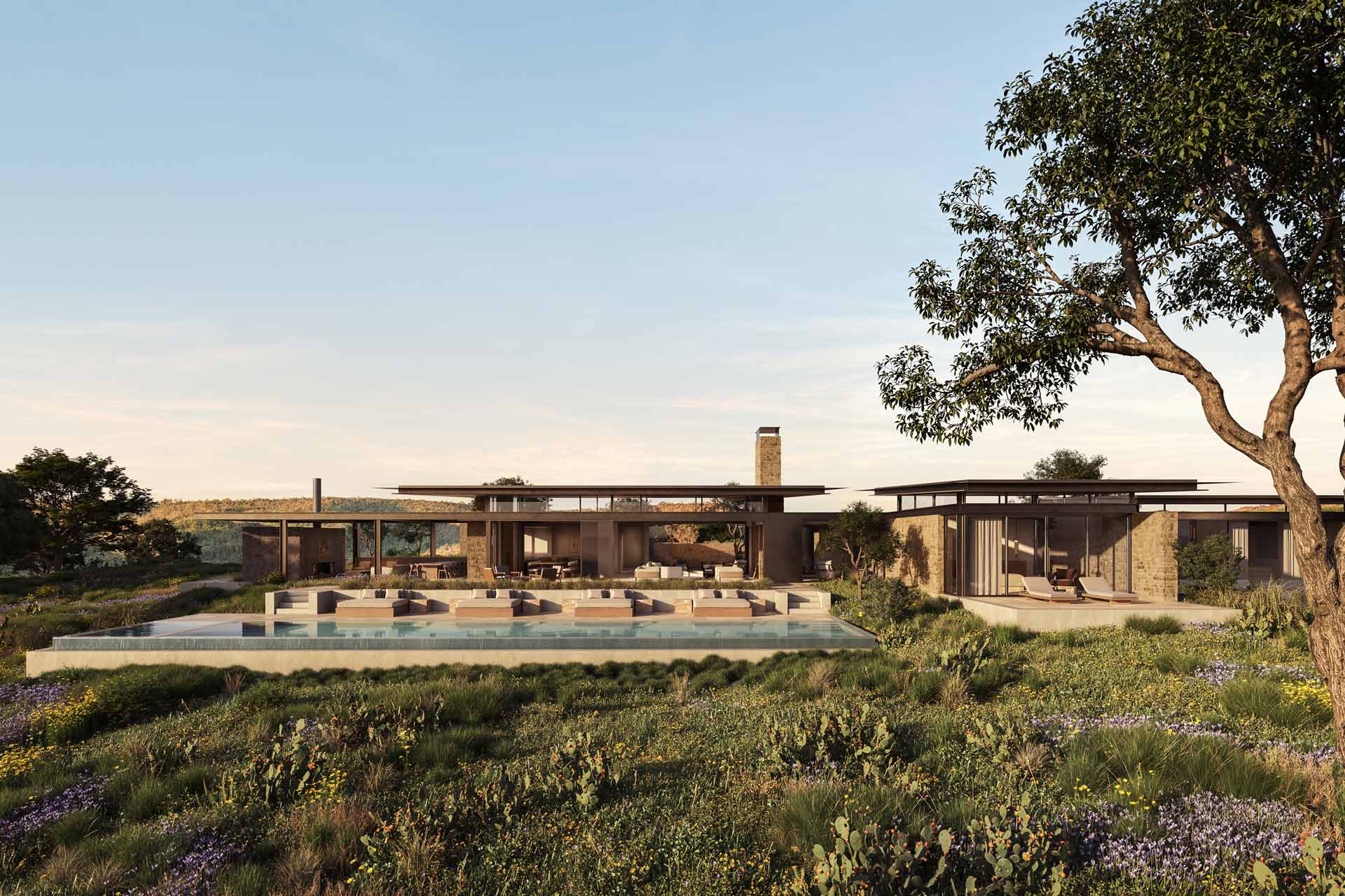 Render showing modern, low-slung buildings by a body of water in a vast, arid landscape