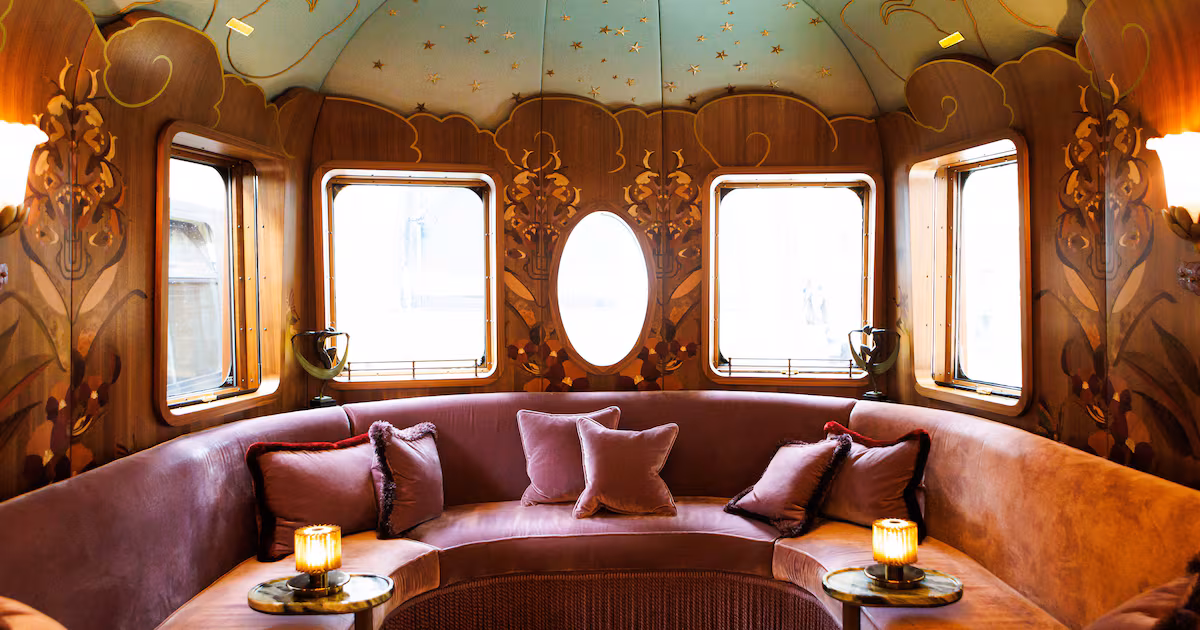 Luxurious, newly redesigned interior of Belmond's Celia train carriage, showcasing Art Deco influences and rich fabrics.