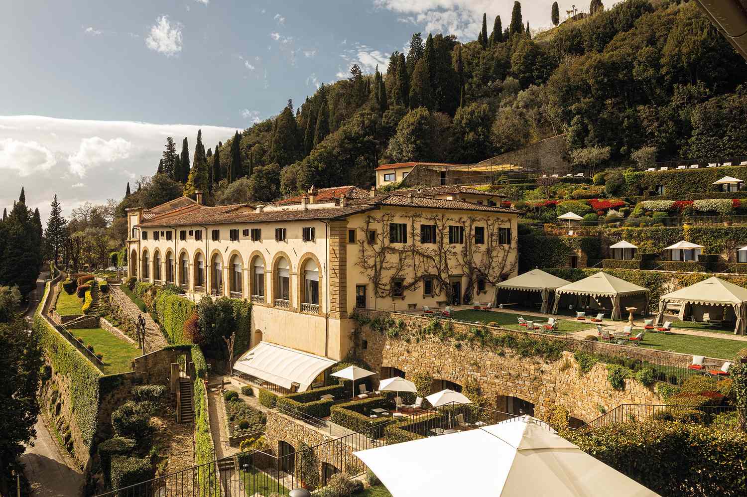 Exterior view of Villa San Michele, a historic building with lush gardens overlooking Florence